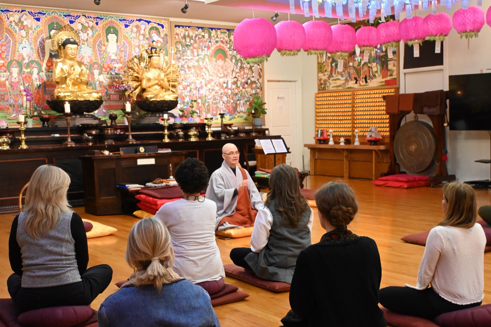 Practitioners gathered on cushions for a Dharma talk with Venerable SooSeong.
